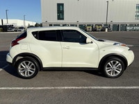 This 2012 Nissan Juke (JAPANESE)is a reliable SUV with a stylish white exterior and a sleek black in... (image 2)