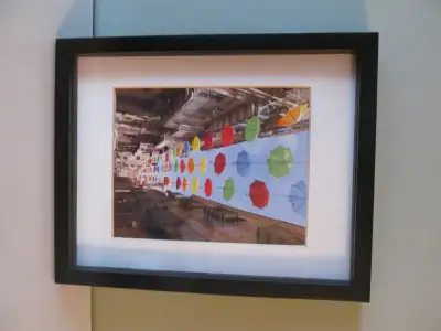 Framed photo of Umbrella lined street in Malta. Very unique and cool.