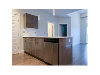 Each suite includes a stainless-steel fridge, stove, dishwasher, and microwave by Whirlpool, as well... (image 5)