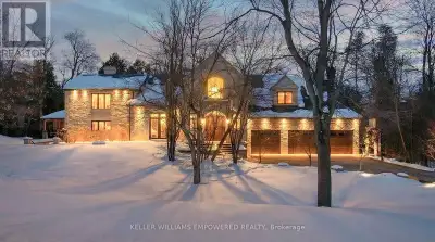 Set behind an automated custom wrought iron gate and framed by towering trees, this estate offers re...