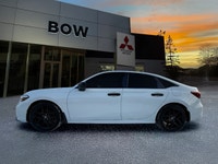 The 2025 Honda Civic Sedan Hybrid Sport in a stunning white finish combined with its FWD drivetrain... (image 7)