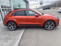 The 2023 Porsche Macan AWD, finished in eye-catching Papaya Metallic, brings true sports car DNA int... (image 6)