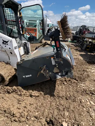 Skid steer attachment street sweeper with an arm to reach the curb and clean it out. as well as an e...