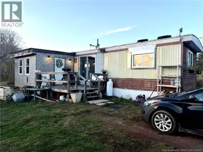 Enjoy the peace and charm of country living with this mobile home overlooking beautiful Washademoak...