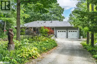EXTRAORDINARY 0.63-ACRE WATERFRONT PROPERTY WITH 103 FT OF PRIVATE SANDY SHORELINE & A METICULOUSLY...
