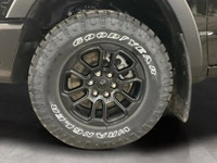 The 2026 Ram 1500 Rebel 4x4 Crew Cab in a striking black hue offers a commanding presence on any ter... (image 8)