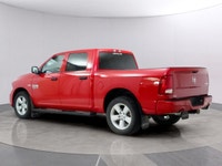 Introducing the Ram 1500 Classic Express 4x4 Crew Cab, a striking red truck that blends power and ca... (image 2)