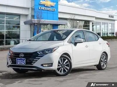 The former daily rental 2024 Nissan Versa SV, dressed in an eye-catching Aspen White TriCoat, presen...