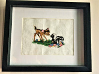 Hand cross stitched Bambi and skunk