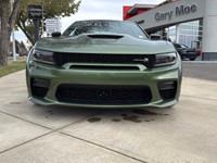 Introducing the dynamic 2023 Dodge Charger Scat Pack 392 Widebody in a striking green, complemented... (image 7)