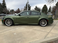 Introducing the dynamic 2023 Dodge Charger Scat Pack 392 Widebody in a striking green, complemented... (image 1)