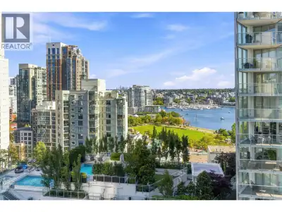 GORGEOUS FALSE CREEK WATER & PARK VIEWS! This bright and open-concept Jr 1 bedroom + den condo offer...