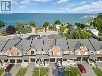 Steps to the beach! Stunning 2022 built spotless 3-bedroom townhome with bay views located in the ch...