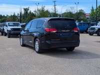 The 2026 Chrysler Grand Caravan SXT in Diamond Black Crystal Pearl with a Black interior offers a bl... (image 3)