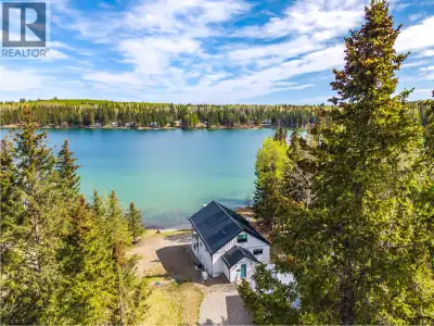 Peaceful waterfront living on sought-after Sheridan Lake. Completely renovated and designed to embra...
