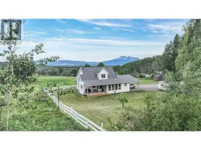 Storybook 80.5-acre acreage framed by a classic white picket fence with sweeping Hudson Bay Mountain...
