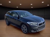 The 2022 BMW X2 xDrive28i Sports Activity Coupe in a sophisticated black finish and equipped with BM... (image 3)