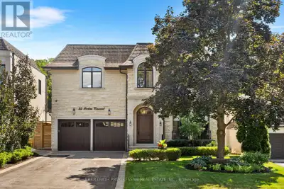 Stunning custom-built luxury residence on a 55 x 120 lot backing onto city greenspace with no rear n...