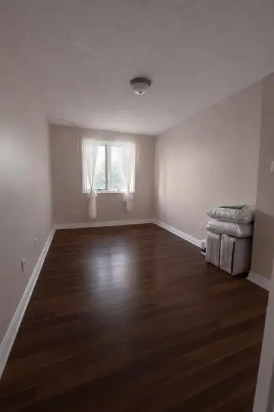 Bright 12x12ft furnished bedroom with closet, modern flooring, and plenty of natural light in a very...