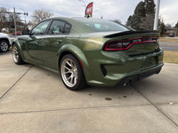 Introducing the dynamic 2023 Dodge Charger Scat Pack 392 Widebody in a striking green, complemented... (image 2)