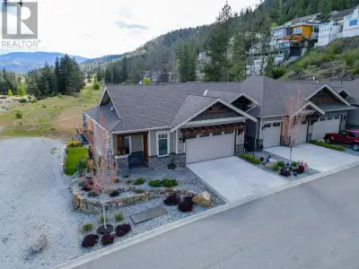 Indulge in unmatched privacy and breathtaking lake and mountain views in this exceptional semi-detac...