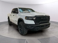 The 2026 Ram 1500 Rebel 4x4 Crew Cab 57 Box is ready to impress with its striking white finish and r... (image 6)
