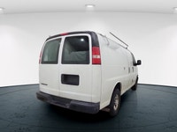 The 2017 Chevrolet Express Cargo Van in a classic white, rear-wheel drive design is tailored for tho... (image 4)
