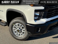The 2026 Chevrolet Silverado 2500HD Work Truck in pristine white and equipped with a rugged 4x4 driv... (image 1)