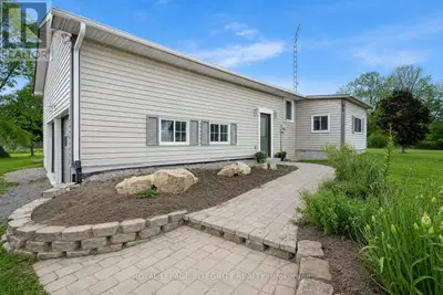 Set on nearly two beautifully landscaped acres, this inviting country property feels like your own p...