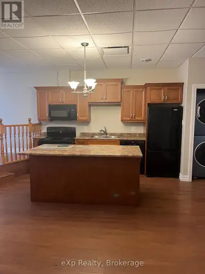 Enjoy convenient downtown living in this bright and spacious two-bedroom apartment located above a q...