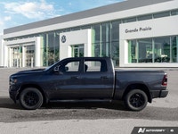 This 2021 Ram 1500 Sport Crew Cab, striking in Granite Crystal Metallic, stands ready for action, bo... (image 1)