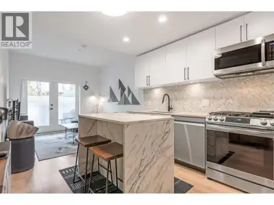 GARDEN-LEVEL END-UNIT at The Trails in Moodyville offering bright, open living and a private fenced...