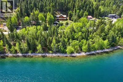 Grand 3,200 sq ft handcrafted log home overlooking the crystal waters of 108 Lake, set on 1.43 priva...