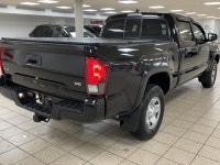 The black paint drinks in daylight like ink, casting sharp reflections across muscular fenders while... (image 5)