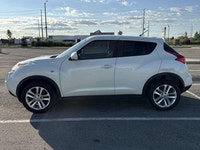 This 2012 Nissan Juke (JAPANESE)is a reliable SUV with a stylish white exterior and a sleek black in... (image 1)