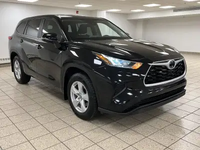 The citys lights ripple across wet pavement as the Midnight Black Metallic finish glides past, its L...