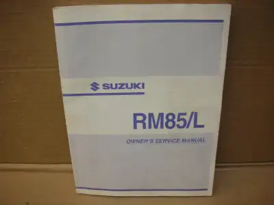 OEM Suzuki owners manual for 2004 RM 85/L excellent condition covers are smudged up a bit from sitti...