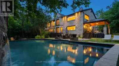 Set behind an automated custom wrought iron gate and framed by towering trees, this estate offers re...