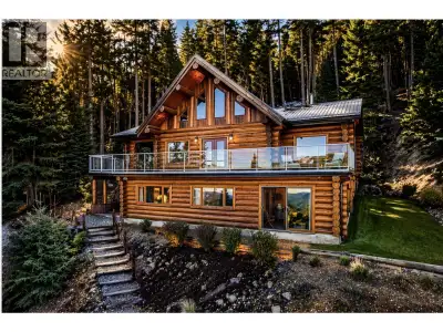 Grand 3,200 sq ft handcrafted log home overlooking the crystal waters of 108 Lake, set on 1.43 priva...