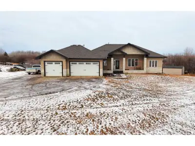 WALKOUT bungalow with attached triple garage (32Wx28L, heated, 220V, water, EV charger) on 2.17 acre...