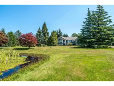 Experience the ultimate lifestyle on this Gorgeous Level Private Parklike 14.11-acre estate on a qui...