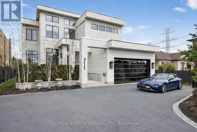 DIRECT WATERFRONT LUXURY. Experience refined lakeside living at 711 Beach Blvd, a 6,700+ sq ft custo...