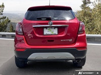 The 2020 Buick Encore Essence, dazzling in Winterberry Red Metallic with a sophisticated Ebony leath... (image 3)