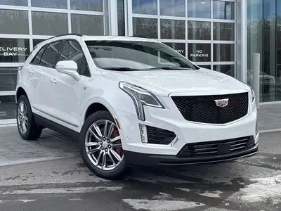 The 2026 Cadillac XT5 Sport AWD, finished in Crystal White Tricoat with a rich Kona Brown interior w...