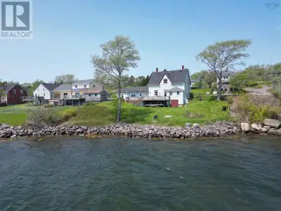 Discover the charm of coastal living with this century-old waterfront home on the shores of Arichat...