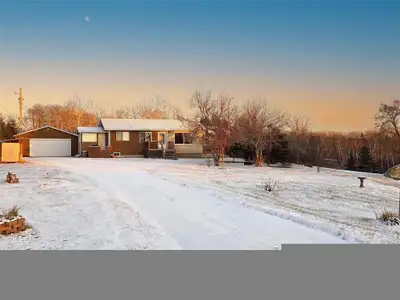 R36//Onanole/Tucked away on a quiet road, this bungalow offers privacy and convenience. Built in 199...