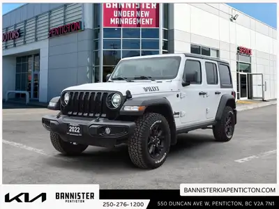 The 2022 Jeep Wrangler Unlimited Willys 4x4 in a classic white exterior and rugged 44 drivetrain is...