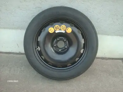 Slightly used O.E. "kit" ("compact wheel, 155/80-19 114M tire and 14X1.5X27 bolts for all models, in...