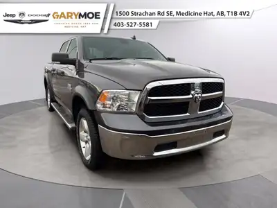 The 2022 Ram 1500 Classic SLT 4x4 Crew Cab stands out with its sophisticated gray exterior and power...