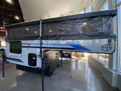 Palomino Real-Lite soft side truck camper SS-1604 highlights: Electric Roof Lift Two Burner Cooktop...